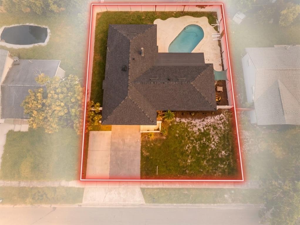 A single-story house with a two-car garage and a concrete driveway at sunset — 2217 SUSSEX ROAD, WINTER PARK, FL
