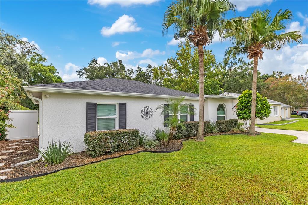 A backyard featuring a swimming pool, concrete patio, landscaping, and a single-story house — 3615 S SUMMERLIN AVENUE, ORLANDO, FL