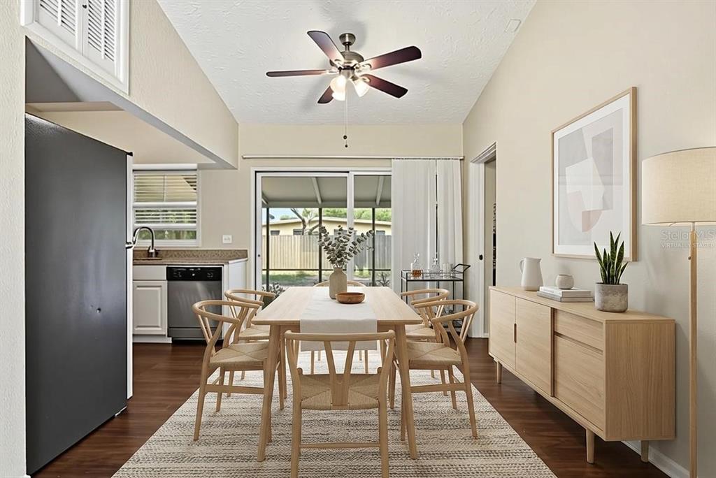 A dining area features a wooden table, chairs, a sideboard, and a sliding glass door — 5312 COVENTRY DRIVE, ORLANDO, FL