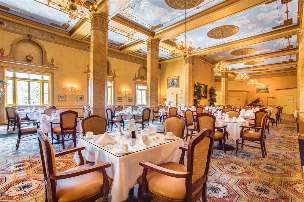 A formal dining room features tables with white tablecloths, ornate columns, and a painted ceiling — 411 1ST AVENUE N UNIT 702, ST PETERSBURG, FL
