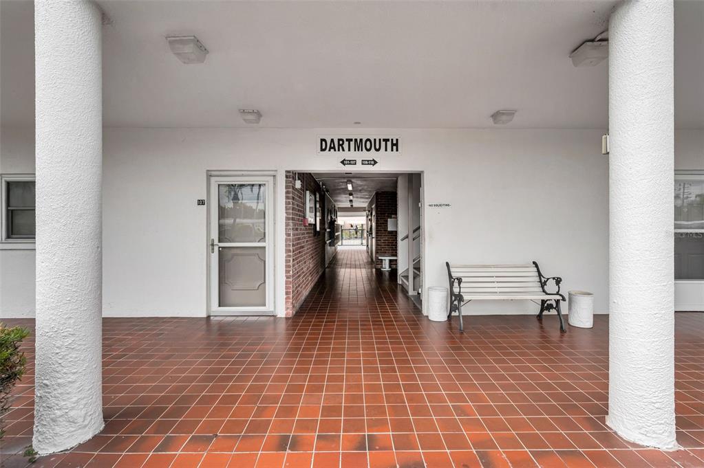 A covered entryway with a tiled floor leads to a building labeled Dartmouth — 5501 80TH STREET N UNIT 405, ST PETERSBURG, FL