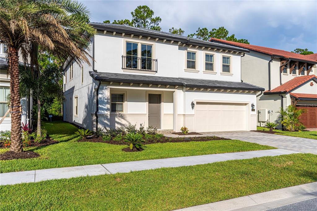 A two-story white stucco house with a tiled roof, a garage, and a palm tree — 10152 ROYAL ISLAND COURT, ORLANDO, FL