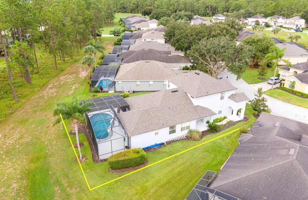An aerial view shows a house with a screened-in pool and a fenced backyard — 360 TUPELO CIRCLE, DAVENPORT, FL