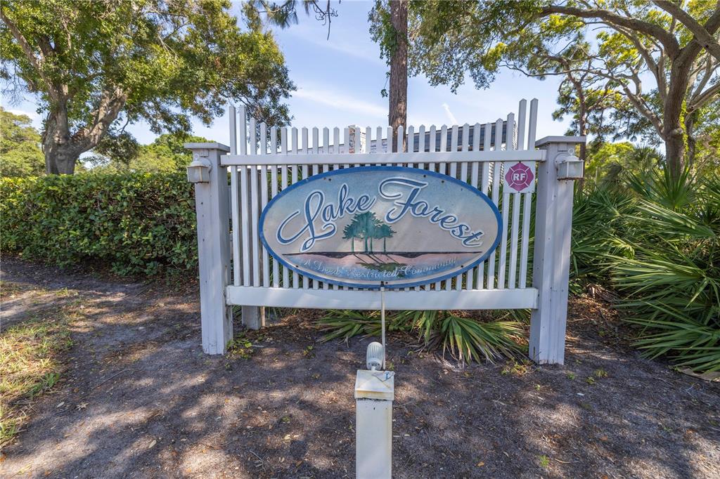 A row of two-story townhomes with attached garages, balconies, and concrete driveways — 6462 92ND PLACE N UNIT 803, PINELLAS PARK, FL