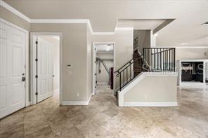 A foyer with tile flooring, a white door, and a staircase with a black railing — 3620 LEOTA DRIVE, APOPKA, FL
