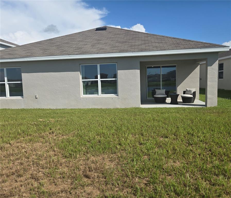 A modern kitchen features white cabinetry, a central island with bar stools, and wood flooring — 10414 CHARLOTTE DRIVE, PARRISH, FL