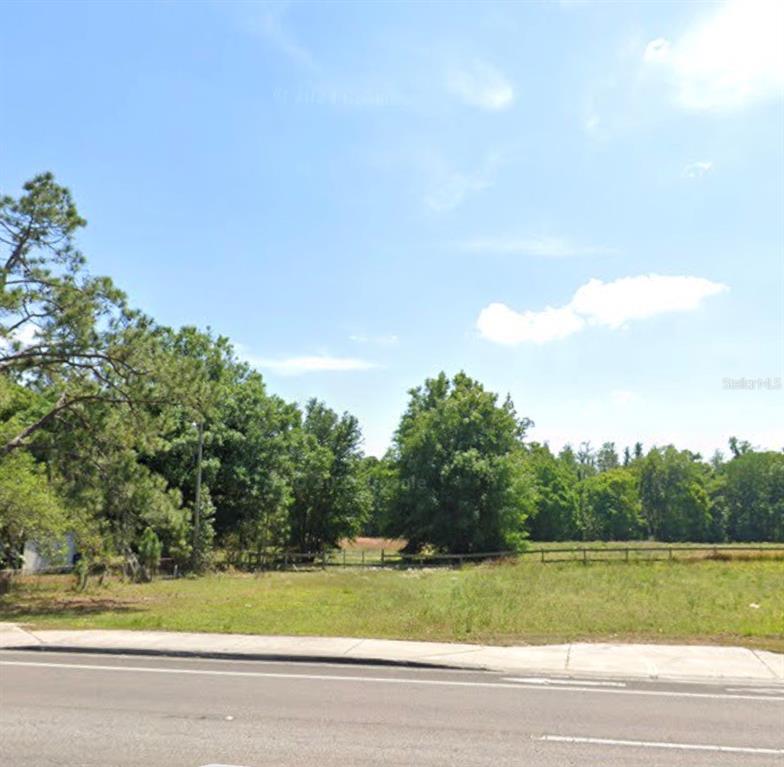 A single-story house with a carport, stone accents, and large oak trees in the yard — 330 MARCUM ROAD, LAKELAND, FL