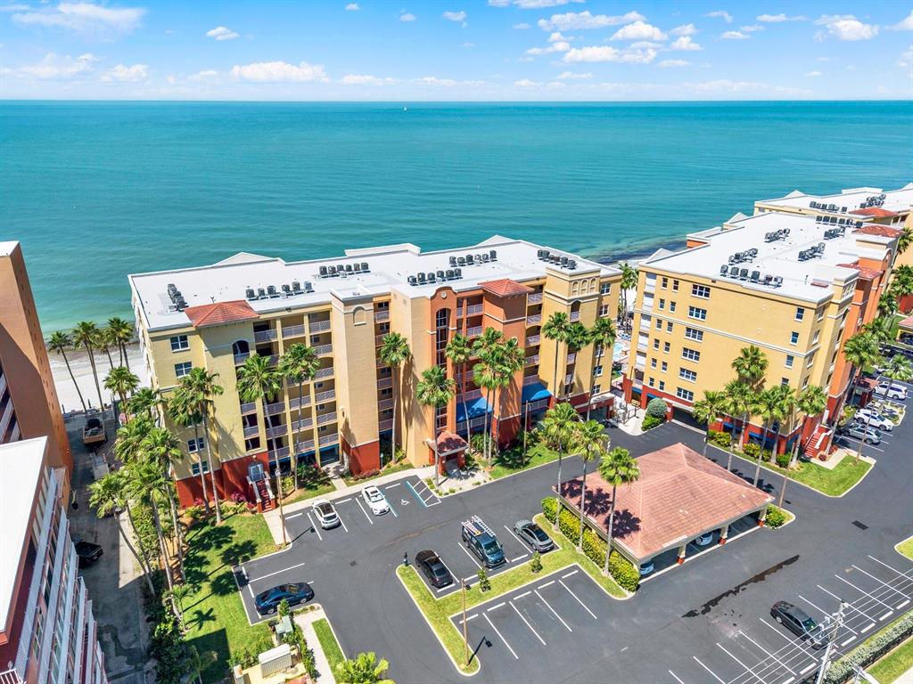An exterior view of a multi-story apartment building with balconies and palm trees — 16450 GULF BOULEVARD UNIT 763, NORTH REDINGTON BEACH, FL