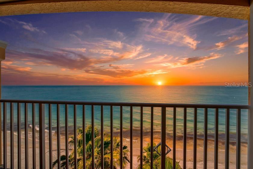 A living room features a gray sectional sofa, a marble coffee table, and a balcony view — 16450 GULF BOULEVARD UNIT 763, NORTH REDINGTON BEACH, FL