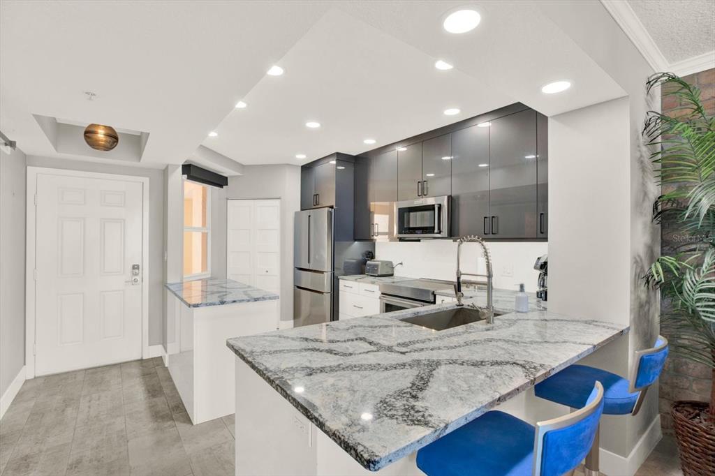 A balcony with tile flooring, outdoor furniture, and ceiling fans overlooks the ocean — 16450 GULF BOULEVARD UNIT 763, NORTH REDINGTON BEACH, FL