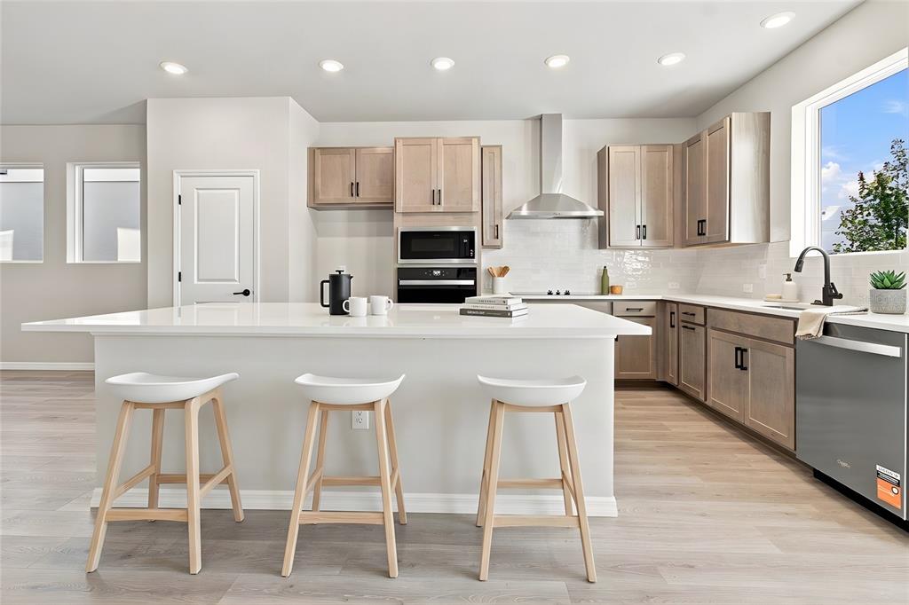 A two-story house exterior features a tan upper level, a gray lower level, and a garage — 3417 YELLOW CASSIA DRIVE, WESLEY CHAPEL, FL