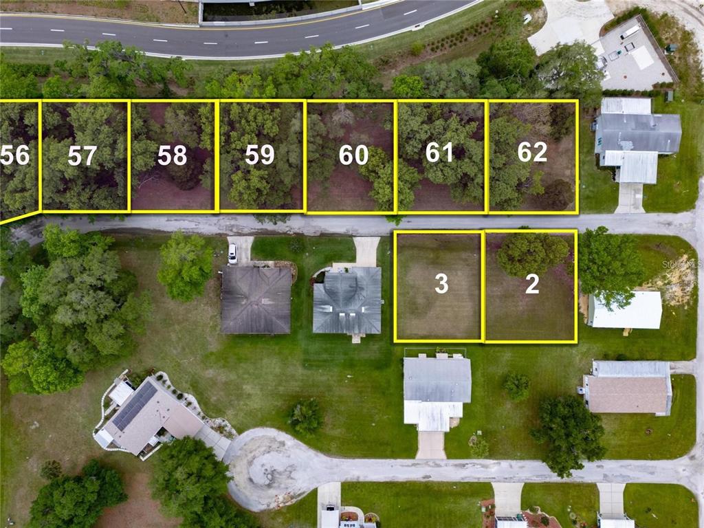 This aerial map shows several numbered residential lots and surrounding houses — LOT 57 BLK C LEXINGTON CIRCLE, WILDWOOD, FL