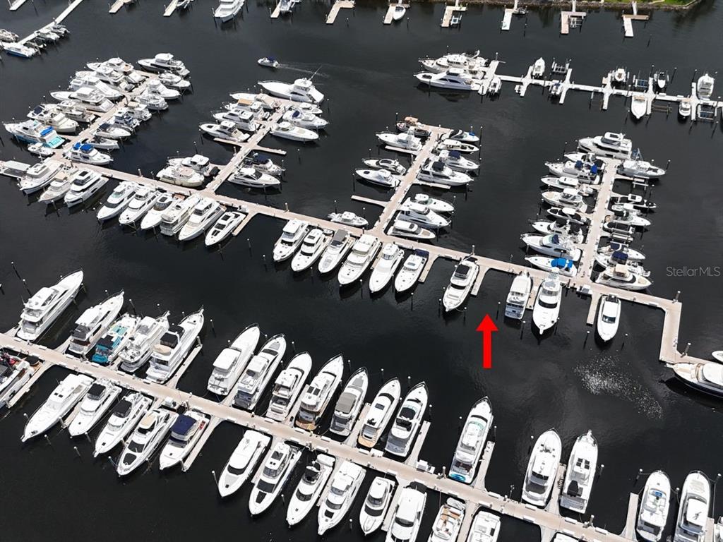An aerial view shows numerous boats docked in slips at a marina — 102 RIVIERA DUNES WAY UNIT S-7, PALMETTO, FL