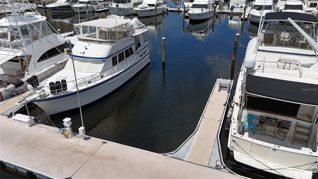 Several white yachts are docked in a marina with concrete piers — 102 RIVIERA DUNES WAY UNIT S-7, PALMETTO, FL