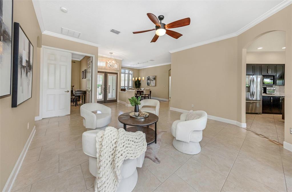 The front exterior of a house features a covered entryway, a walkway, and two palm trees — 3675 JANUS WAY, PALM HARBOR, FL