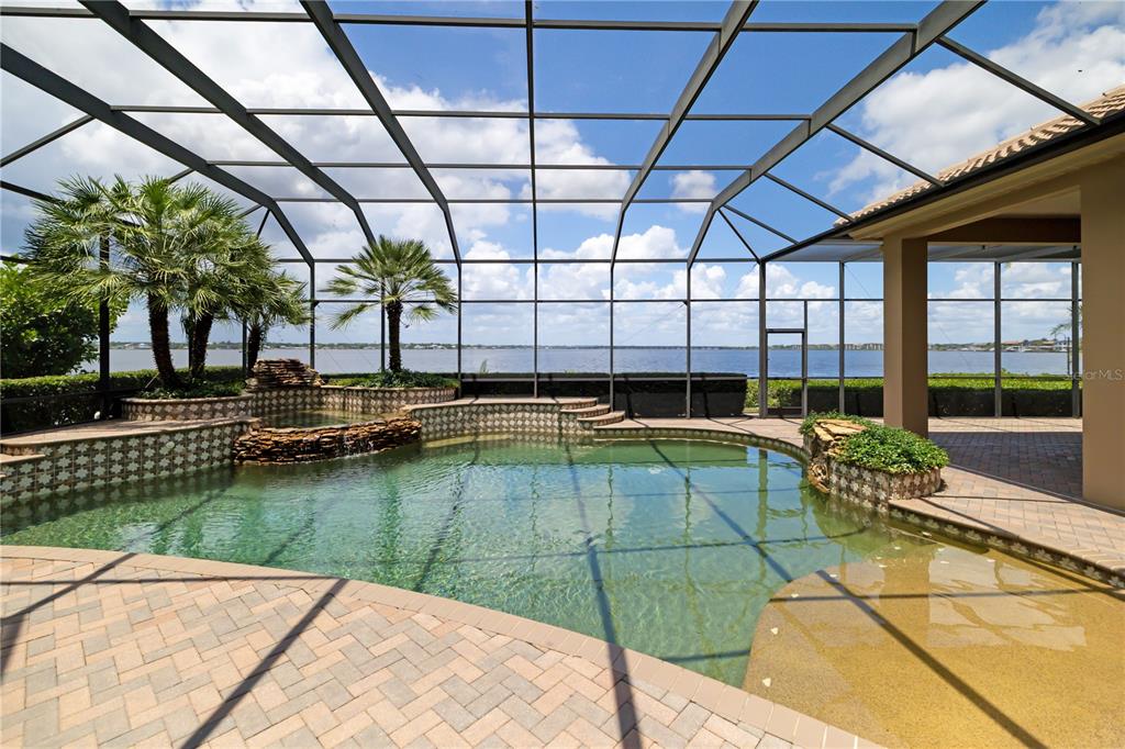 An aerial view shows several waterfront homes with swimming pools and private docks at dusk — 3803 HAWK ISLAND DRIVE, BRADENTON, FL