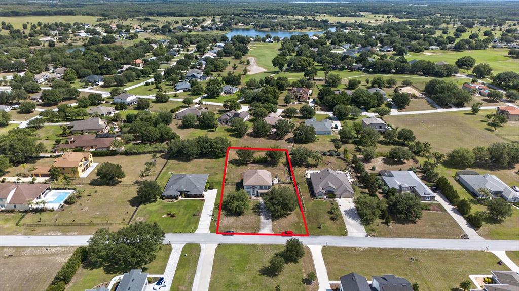An aerial view shows a single-family home outlined in red on a suburban lot — 24215 WELDON DRIVE, EUSTIS, FL