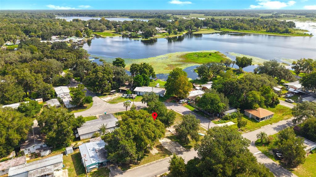 An aerial view shows a vacant lot marked with a red pin near a lake — 4672 N APACHE TRAIL, HERNANDO, FL