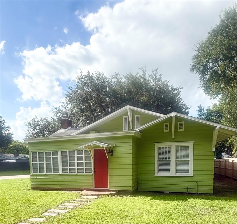 A room with red flooring and white walls opens into an adjacent room with shelving — 1903 CURRY FORD ROAD, ORLANDO, FL