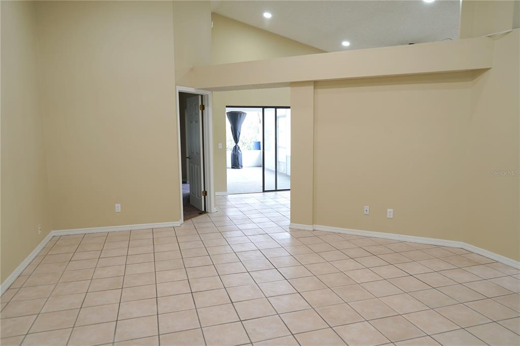 A kitchen with wood cabinets and a breakfast bar overlooks a tiled dining area — 4304 BARRET AVENUE, PLANT CITY, FL