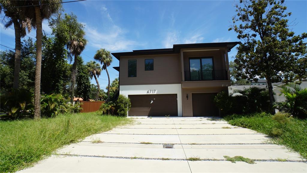 A two-story modern house with a two-car garage and a paved driveway — 4717 W ESTRELLA STREET, TAMPA, FL