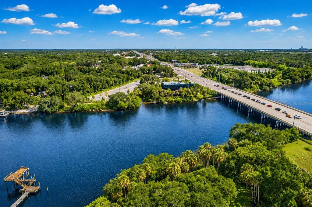 An aerial view shows a bridge crossing a river with surrounding trees and a dock — RIVERVIEW DRIVE, RIVERVIEW, FL