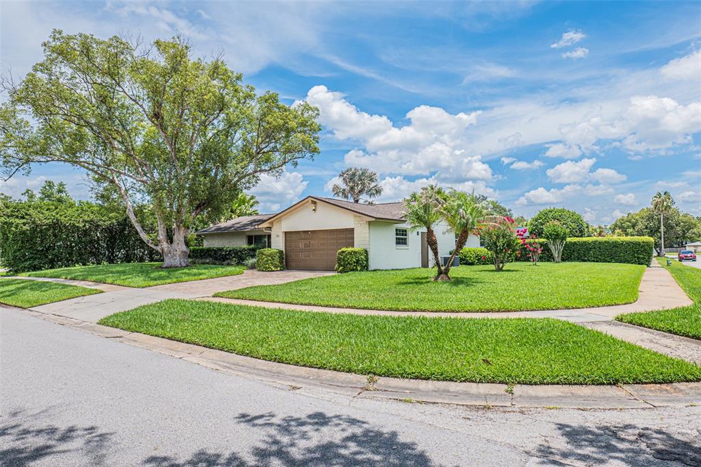 A single-story house with a large tree in the front yard and a wooden fence — 741 BROOKSIDE ROAD, MAITLAND, FL