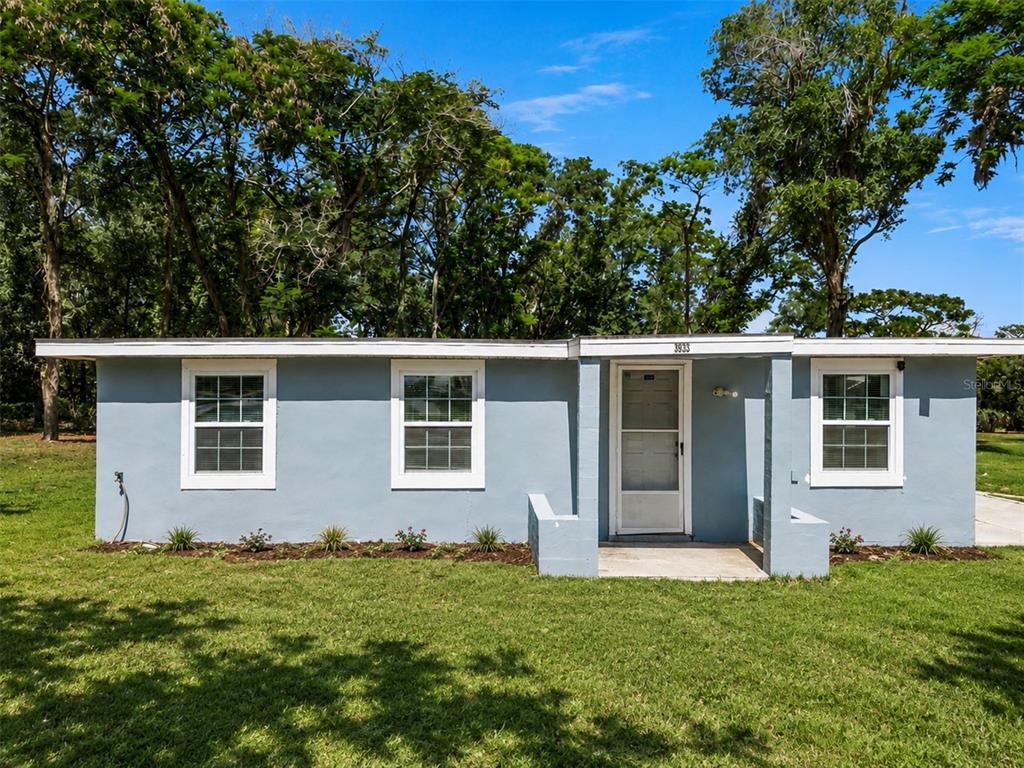 An aerial view shows a rectangular lot with a small house and dense tree coverage — 3932 WHITE HERON DRIVE, ORLANDO, FL