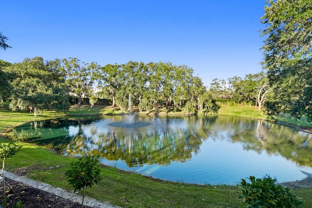 An aerial view of a large two-story white house with a tiled roof and pool — 9725 CHESTNUT RIDGE DRIVE, WINDERMERE, FL