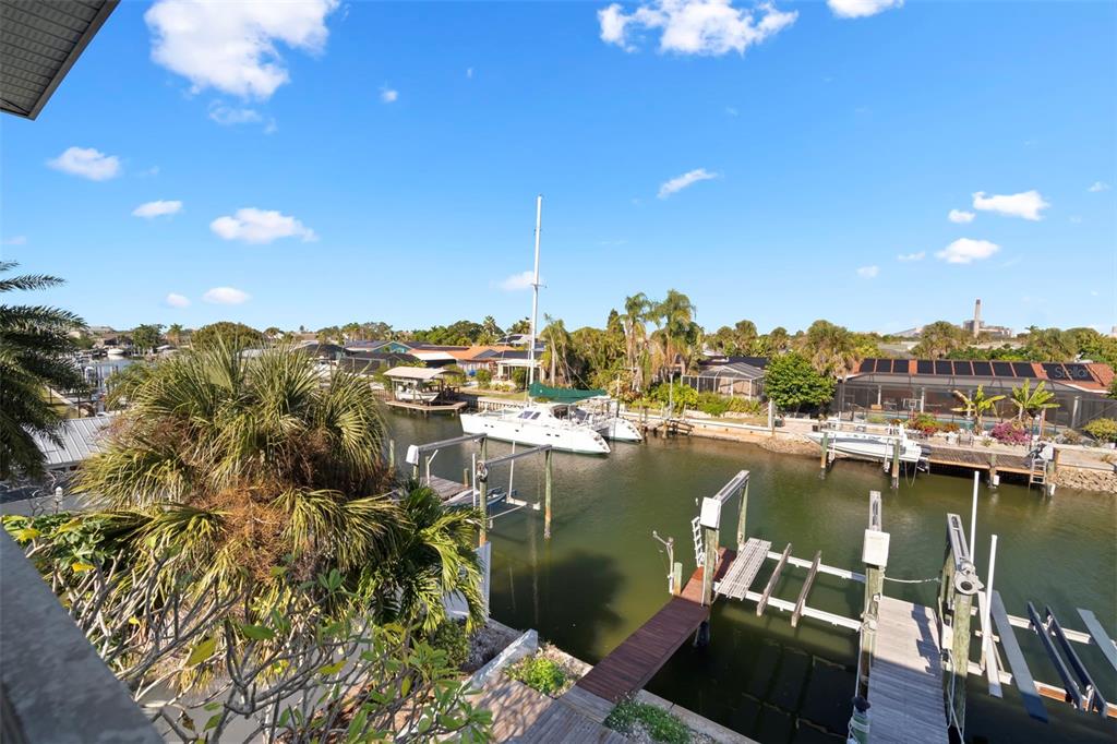 An elevated view of a canal with a sailboat, boat docks, and surrounding residential homes — 1013 APOLLO BEACH BOULEVARD UNIT 203, APOLLO BEACH, FL
