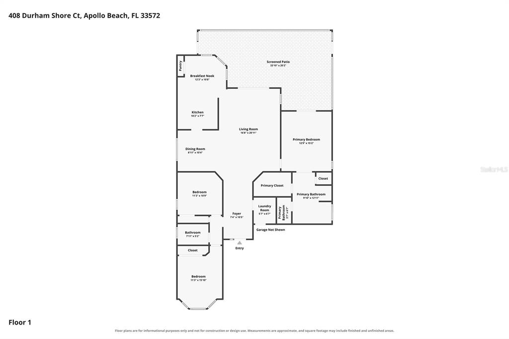 A living room with tile floors, a sliding glass door, and an adjacent kitchen area — 408 DURHAM SHORE COURT, APOLLO BEACH, FL