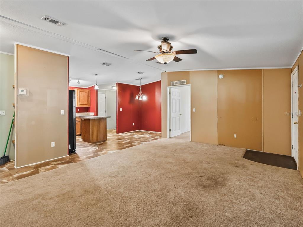 A covered wooden deck features exposed ceiling joists, screen walls, and a wooden gate — 3861 CR 519, COLEMAN, FL