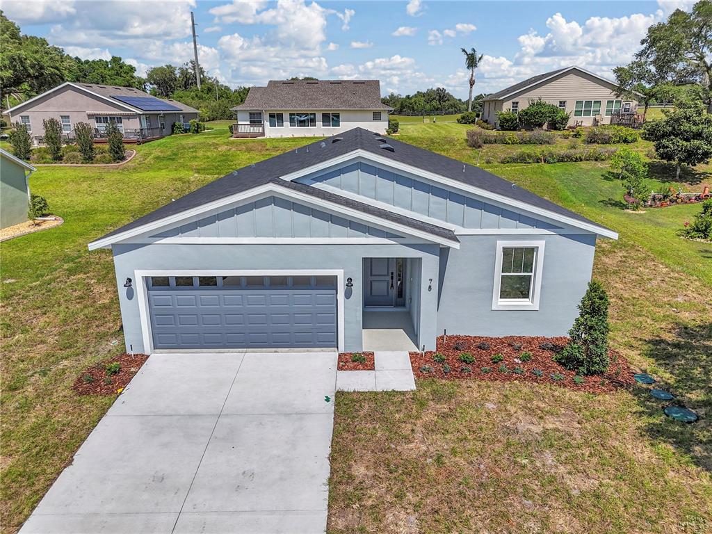 An aerial view of a light blue single-story house with a two-car garage — 78 FAIRWAY CIRCLE, UMATILLA, FL