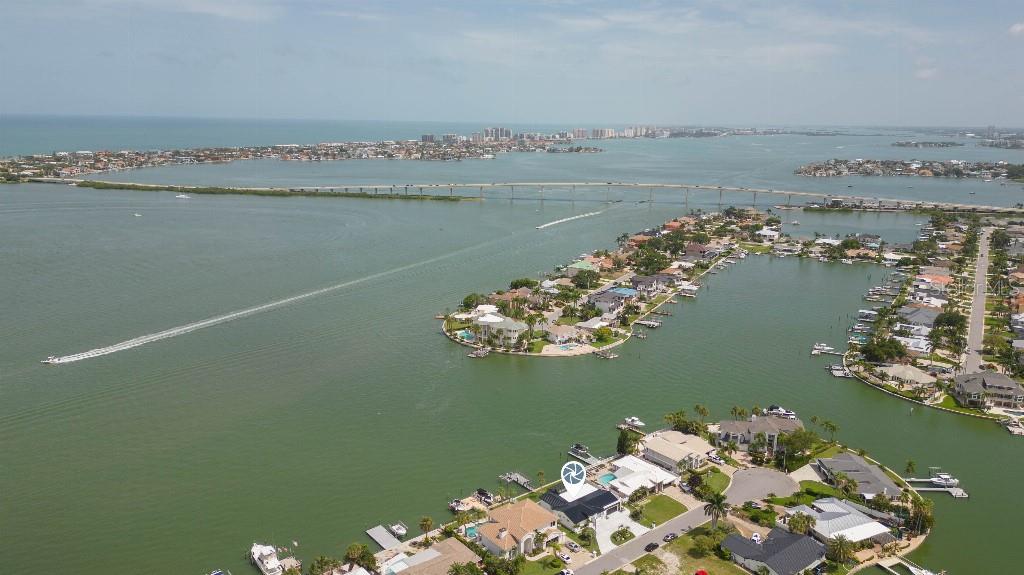 An aerial view of a waterfront home with a dark roof and a boat dock — 306 BUTTONWOOD LANE, LARGO, FL