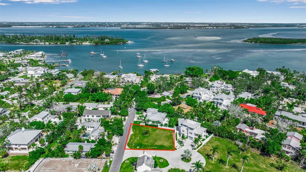 An aerial view shows a vacant rectangular lot outlined in red within a coastal neighborhood — 610 HIBISCUS WAY, LONGBOAT KEY, FL