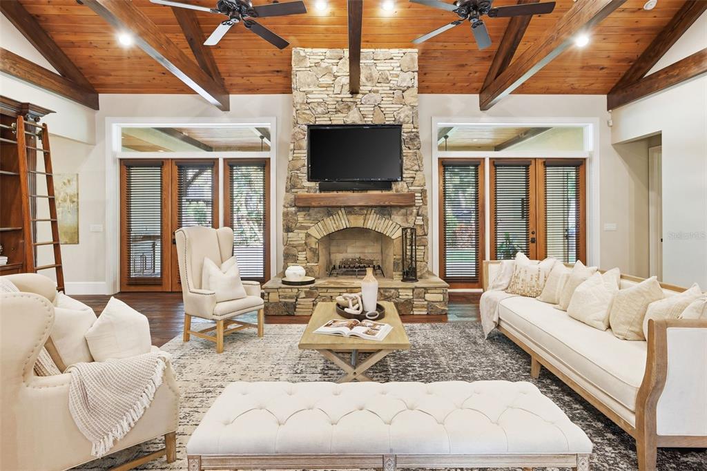 A two-car garage with wood-look doors and a paver driveway in front of a house — 713 MAIN STREET, WINDERMERE, FL