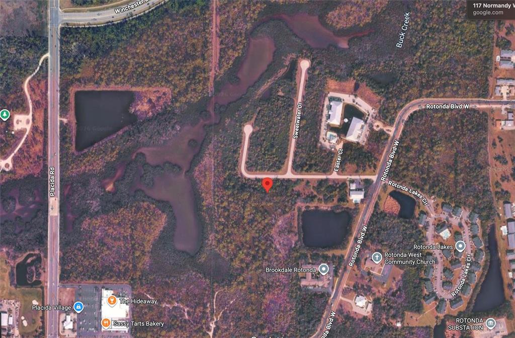 This is an aerial map view showing a vacant lot marked with a red pin — 117 NORMANDY WAY, ROTONDA WEST, FL
