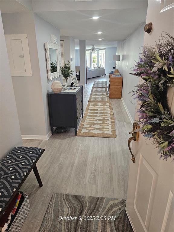 An entryway leads into a hallway with light wood flooring, a runner rug, and furniture — 6500 SUNSET WAY UNIT 308, ST PETE BEACH, FL