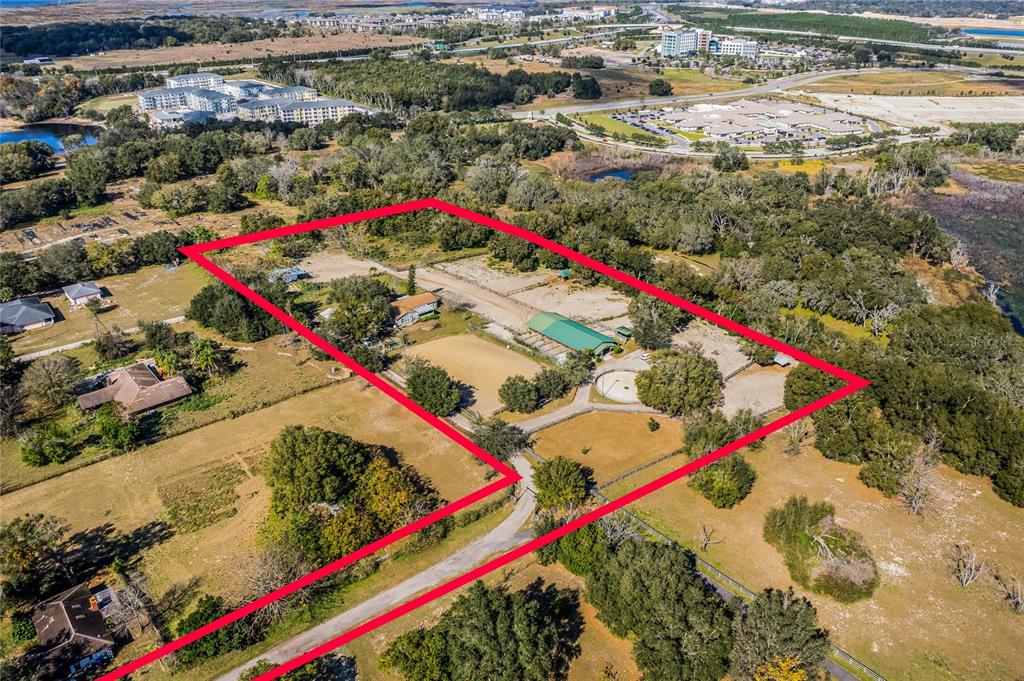 An aerial view shows a rural property with a house, barn, and fenced pastures — 1455 W KEENE ROAD, APOPKA, FL