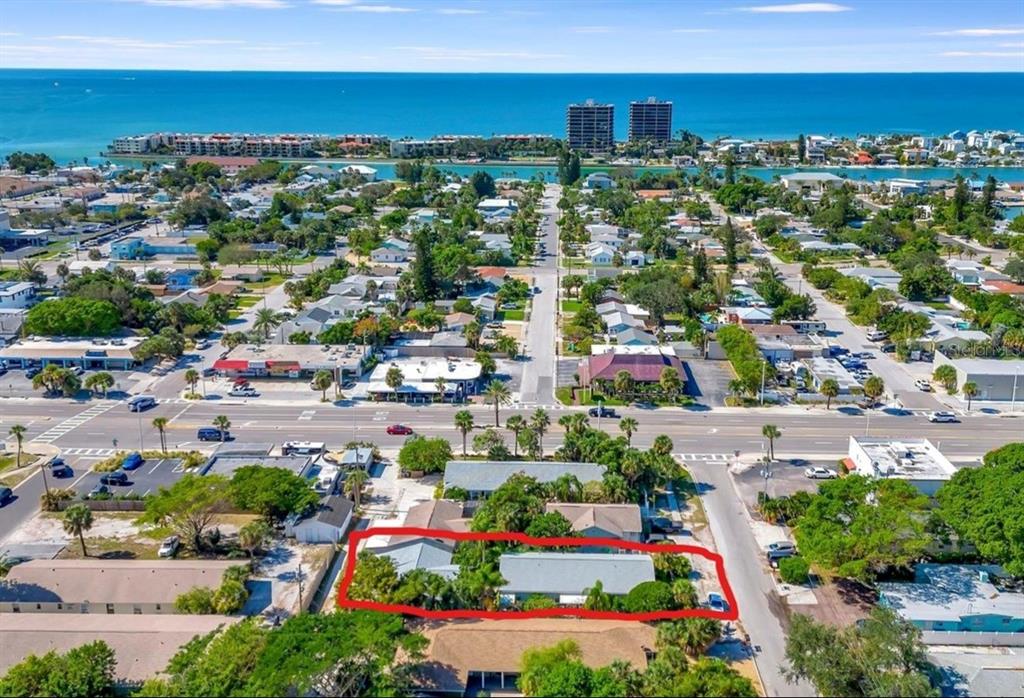 An aerial view shows a residential property outlined in red near a coastal town — 340 78TH AVENUE, ST PETE BEACH, FL