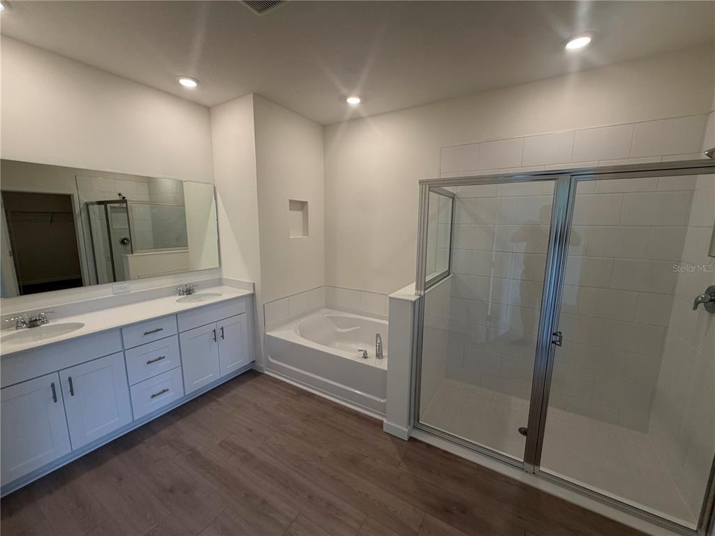 A waiting area with two leather chairs leads into a gym through double glass doors — 3024 KINGSMAN TRAIL, ORMOND BEACH, FL