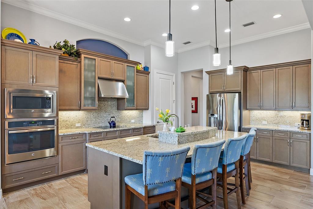A living room features a coffered ceiling, blue accent wall, tile flooring, and built-in shelving — 11739 RIVER SHORES TRAIL, PARRISH, FL