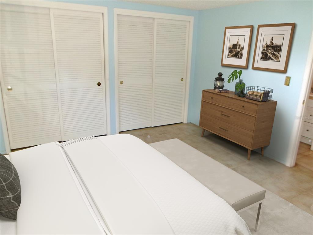 A bedroom features white louvered closet doors, a wooden dresser, and light blue walls — 12709 CLOCK TOWER PARKWAY, HUDSON, FL