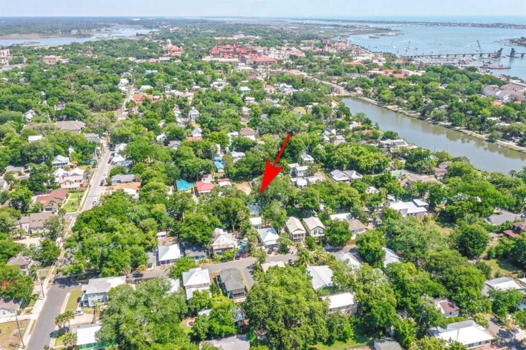 An aerial view shows a residential neighborhood with a red arrow pointing toward a property — 19 LOVETT STREET, ST AUGUSTINE, FL