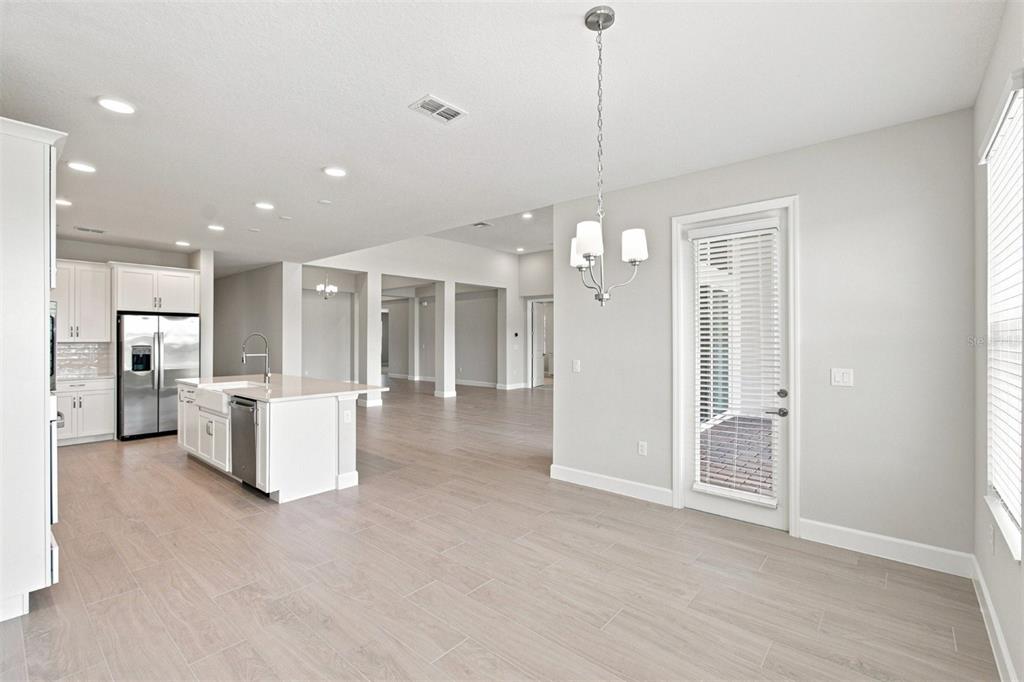An unfinished interior space features white walls, recessed lighting, and protective paper on the floor — 17036 OVERSTORY ROAD, ORLANDO, FL