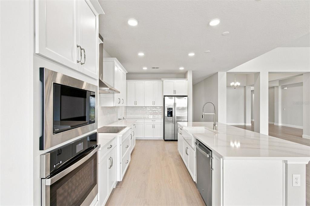 An unfinished open-concept room features white walls, recessed lighting, and protective paper on the floor — 17036 OVERSTORY ROAD, ORLANDO, FL
