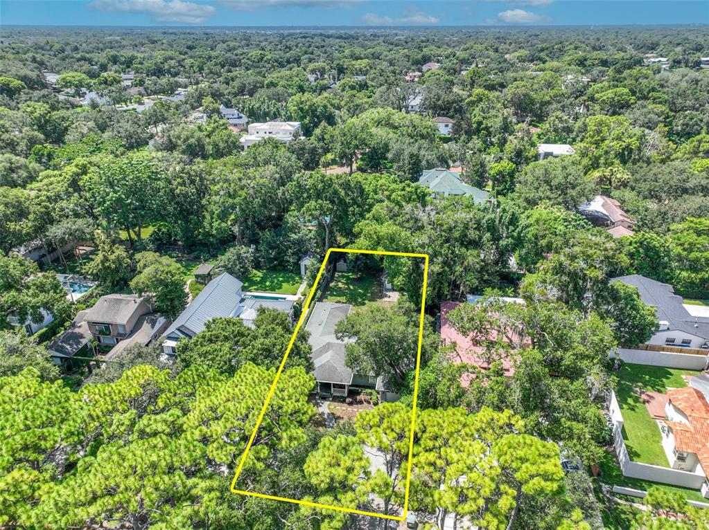 An aerial view shows a single-story house surrounded by dense trees within a yellow outline — 150 E READING WAY, WINTER PARK, FL