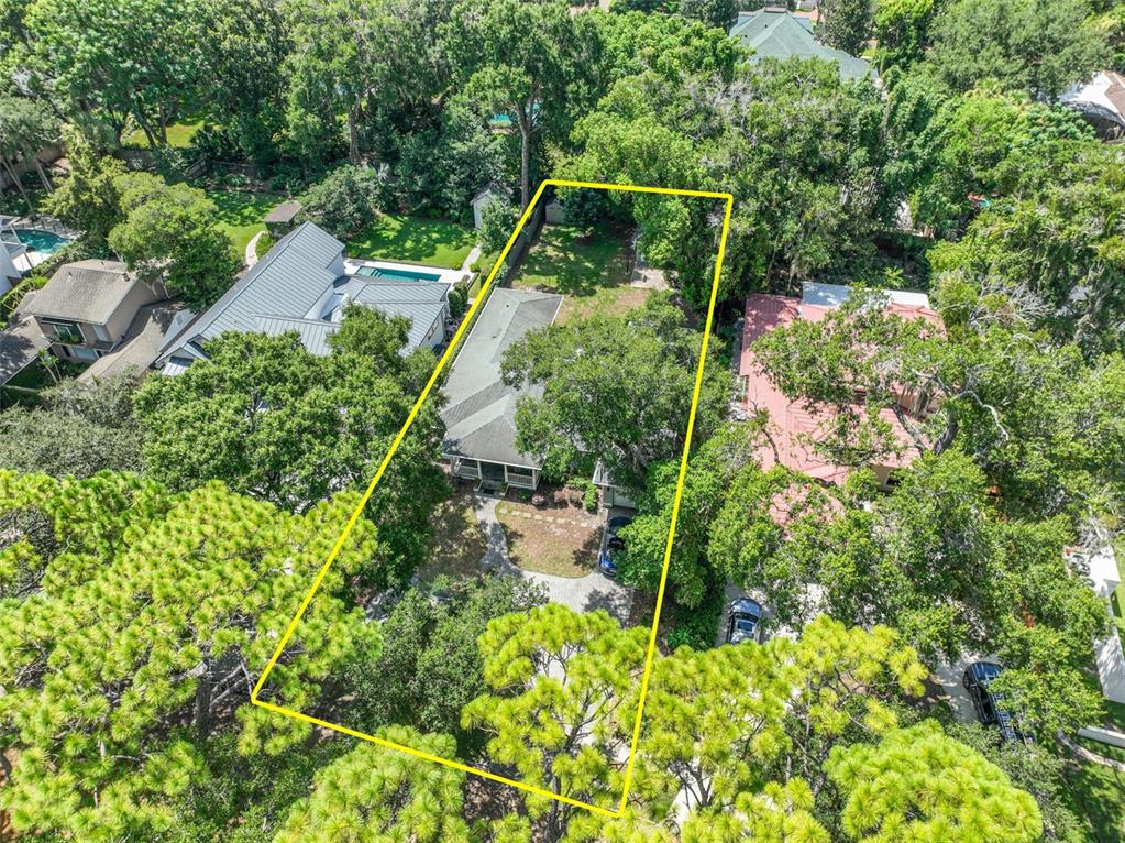An aerial view shows a house with a large backyard outlined in yellow among trees — 150 E READING WAY, WINTER PARK, FL