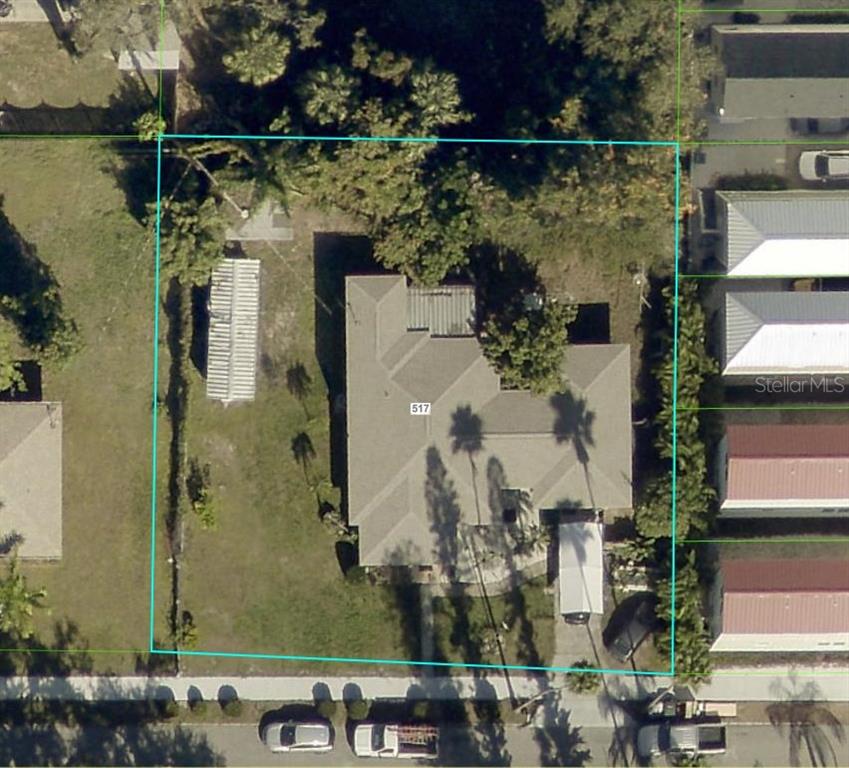 This aerial view shows a residential property with a house, yard, and driveway — 517 4TH AVENUE E, BRADENTON, FL