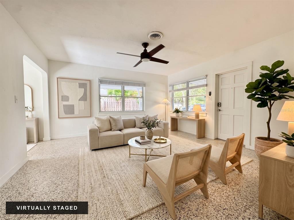 An empty room with white walls, a ceiling fan, and speckled flooring — 4722 STEVENS DRIVE, SARASOTA, FL